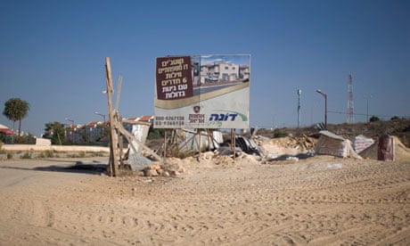 A sign promotes a new housing project at a construction site in Ariel