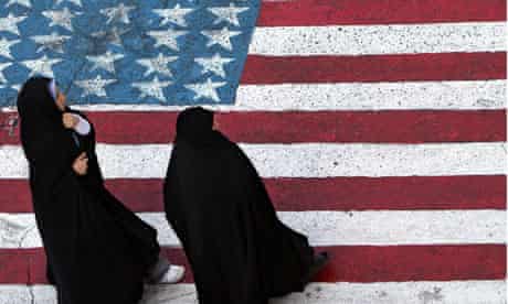 Iranian women walk on a US flag in Tehran