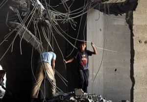 Israeli air strikes: Palestinians survey the bomb damage to a Hamas building