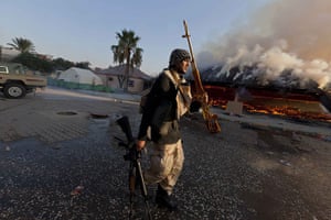 Raids in Tripoli: A rebel fighter displays a looted golden gun