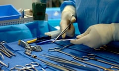 Support staff prepares surgical tools in an operating theater prior to a kidney transplant operation