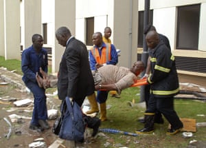 UN Abuja bomb blast: An injured man is carried from a United Nation's office