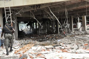 UN Abuja bomb blast: A police officer walks past the blast shattered United Nations building