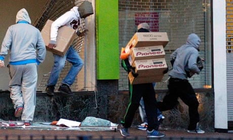 Looters carry boxes out of a shop in Birmingham