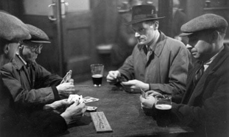 The patrons of a pub in south London play the card game cribbage in 1949