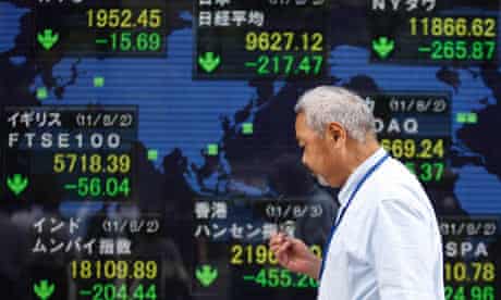 An electronic board showing falls in market indices around the world outside a brokerage in Tokyo