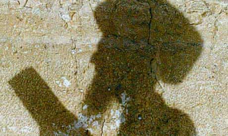 Shadow of an Orthodox Jewish man on the Western Wall in Jerusalem