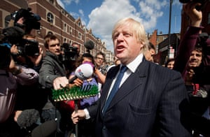 London riots day 4: Boris Johnson addresses the crowd holding a broom in Clapham