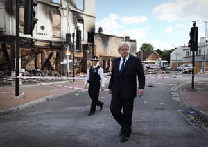 London riots day 4 update: Boris Johnson walks near burnt out Reeves Corner furniture store in Croydon