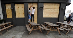 London riots day 4 update: A publican boards up his pub in central London