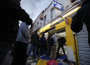 London Riots: Rioters are seen looting a shop in Hackney
