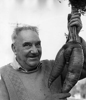 Giant vegetables: Bob Eynstone holding up a large five-pound carrot from his garden