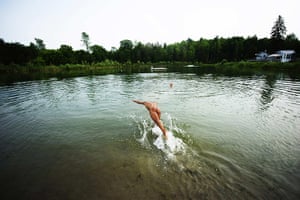 FTA: Mark Blinch: A man dives into the water at the Bare Oaks Family Naturist park in Sharon