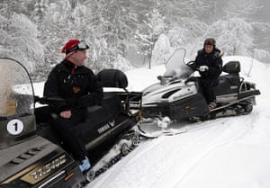 Putin: Vladimir Putin and President Dmitry Medvedev drive snowmobiles near Sochi
