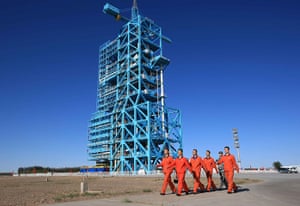 China space launch: Staff worker walk to inject fuel for the Long March-II F carrier rocket