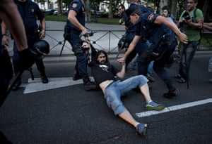 24 Hours:  Police officers detain a man during a demonstration in Madrid