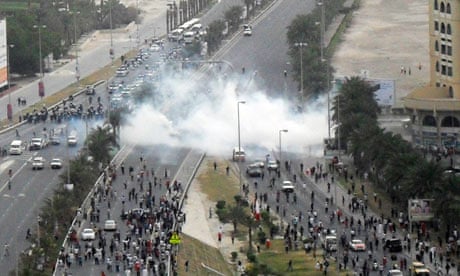 Tear gas explodes among protesters on a main road