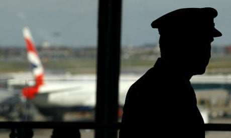A pilot waits in the departure lounge of BA's Terminal Five at Heathrow Airport