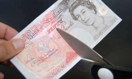 Fifty pound note cut with scissors