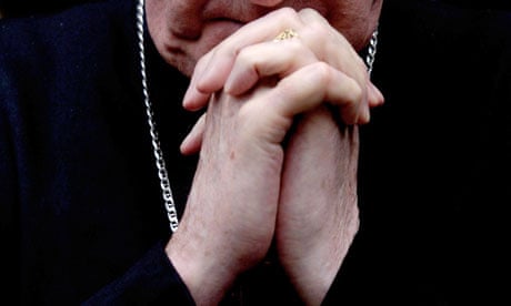 A priest's hands clasped in prayer