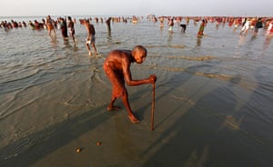 Ganges: A pilgrim walks back after taking a holy dip