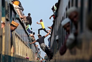 24 hours in pictures: Muslims climb up on to a train at Tongi Railway station, Bangladesh