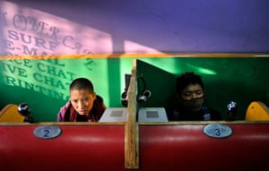 24 hours in pictures: Tibetans surf the internet at an internet cafe in New Delhi, India