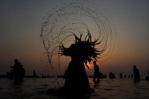 24 hours in pictures: An Indian Sadhu takes a dip in the sea at Gangasagar