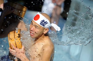 24 hours in pictures: A participant pours icy water at purification ceremony in Tokyo