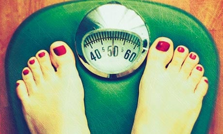 Person weighing themselves on scales