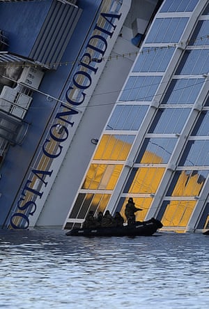 Concordia: Navy rescuers sit in a dinghy next to the stricken Costa Concordia