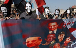 Egypt one year rally: Protesters wear masks depicting slain Coptic activist Mina Daniel