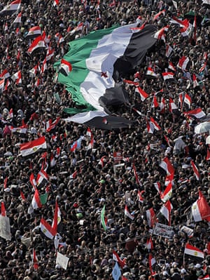 Egypt one year rally: Protesters gathered around a giant Syrian national flag in Tahrir square 