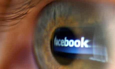 Facebook logo reflected in a computer user's eye