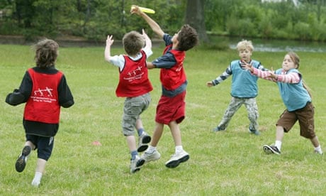 Schoolchildren play with a frisbee