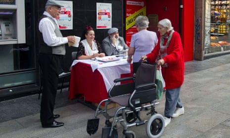 Red Cross volunteers collect money in the street, in Madrid, Wednesday Oct. 10, 2012. 