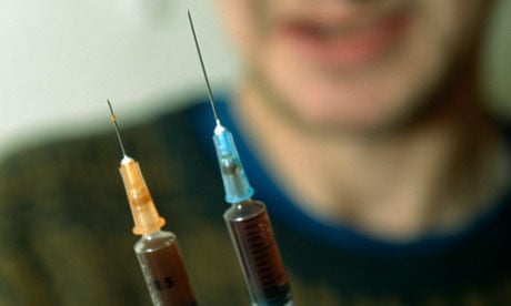 A drop of heroin runs down the needle