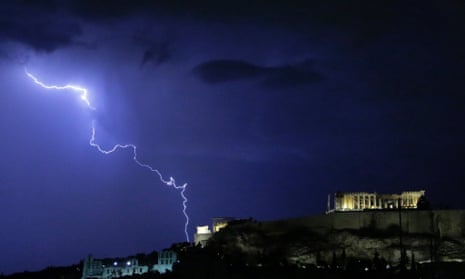 Lightening illuminates the ancient Parthenon temple atop the Acropolis hill in Athens on Sunday Oct. 14, 2012.