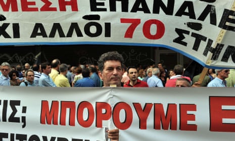 A metal worker from a factory in Thessaloniki holds a banner during a demonstration outside the labour ministry in Athens on October 15, 2012. The workers ask for the government to find a solution after the factory stopped production and ceased to pay the salaries for 17 months.