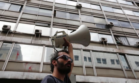 A worker raises a loudspeaker during an anti-austerity rally outside the Labour Ministry in Athens October 15, 2012.