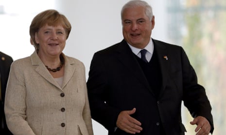 German Chancellor Angela Merkel, left, and the President of Panama, Ricardo Martinelli, right, arrive for a joint press conference after a meeting at the chancellery in Berlin, Germany, Monday, Oct. 15, 2012.