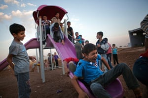 FTA: Maysun: Syrian refugee children play on a slide in a camp