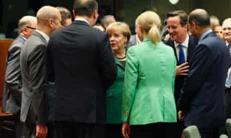 Angela Merkel and David Cameron chat with other leaders at a European Union leaders summit in Brussels.