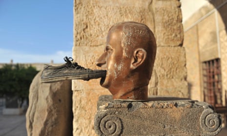 A shoe is seen glued to a statue of late Syrian president Hafez al-Assad, at the museum of Maarat al-Numan, in the northwestern Idlib province, on October 17, 2012.