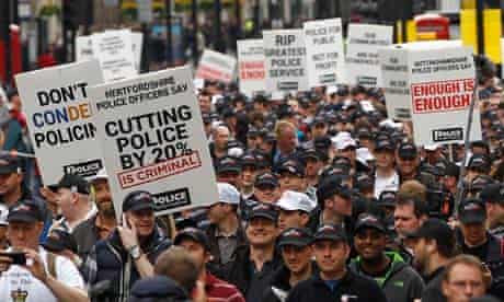 Off-duty police officers march in protest at funding cuts through central London May 10 2012. 
