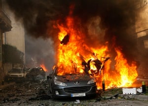 Beirut car Bomb: A car burns at the site of an explosion
