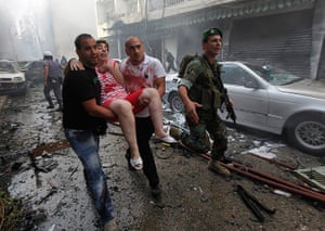 Beirut car Bomb: An injured woman is carried away by civilians