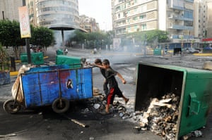 Beirut car Bomb: Lebanese boys push a cart through a road block