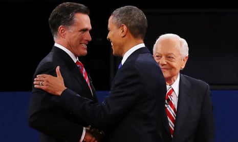 Barack Obama greets Mitt Romney moderator Bob Schieffer of CBS looks on.