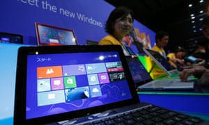 People try out Microsoft Corp's Windows 8 operating system at an event for its debut at the Akihabara electronics store district in Tokyo